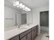 Bright bathroom featuring double sinks, a large mirror, modern lighting, and a separate shower and toilet area at 2650 Howard Ave, Oviedo, FL 32765