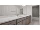 This bathroom features a double vanity, gray cabinets, and a shower-tub combo at 2650 Howard Ave, Oviedo, FL 32765