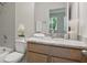 Bathroom featuring gray tiled walls, marble countertops, and a light wood vanity at 2650 Howard Ave, Oviedo, FL 32765