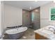 Modern bathroom featuring a standalone tub, glass shower, and elegant finishes at 2650 Howard Ave, Oviedo, FL 32765