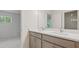 Bright bathroom with double sink vanity, modern fixtures, and a view into the bedroom at 2650 Howard Ave, Oviedo, FL 32765