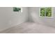 Neutral bedroom with carpet, bright light from surrounding trees, and base molding at 2650 Howard Ave, Oviedo, FL 32765