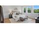 Bright main bedroom boasts a cozy seating area and three large windows at 2650 Howard Ave, Oviedo, FL 32765