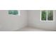 This bedroom features neutral walls and carpet and two windows that provide natural light at 2650 Howard Ave, Oviedo, FL 32765