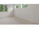 This bedroom features neutral walls and carpet and multiple windows that provide natural light at 2650 Howard Ave, Oviedo, FL 32765