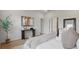 Bright bedroom featuring wood floors, console table with decor, and a comfortable bed with plush pillows and throw at 2650 Howard Ave, Oviedo, FL 32765