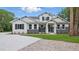 New construction home featuring white wood facade, black shutters, and a concrete driveway at 2650 Howard Ave, Oviedo, FL 32765