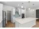 Modern kitchen with quartz countertops, stainless steel appliances, and a large island for entertaining at 2650 Howard Ave, Oviedo, FL 32765
