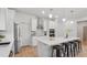Open kitchen with a large island, stainless steel appliances, and modern lighting at 2650 Howard Ave, Oviedo, FL 32765