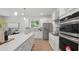 Modern kitchen features white cabinets, stainless steel appliances, and a spacious island at 2650 Howard Ave, Oviedo, FL 32765