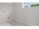 Bright laundry room with tile flooring, shelf, hookups, and a window at 2650 Howard Ave, Oviedo, FL 32765