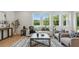 Bright living room with large windows, comfortable seating, and modern decor at 2650 Howard Ave, Oviedo, FL 32765