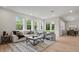 Spacious living room with bright windows, comfortable seating, and a stylish rug at 2650 Howard Ave, Oviedo, FL 32765