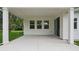 This patio features a concrete floor, white columns, and a view of the lawn at 2650 Howard Ave, Oviedo, FL 32765