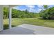 Picturesque patio view overlooking a lush green lawn and mature trees, providing a serene and private outdoor space at 2650 Howard Ave, Oviedo, FL 32765