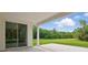 This porch features a concrete floor, white railings and trim, and a large green yard at 2650 Howard Ave, Oviedo, FL 32765