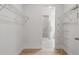 Walk-in closet with wire shelving, wood floor, and view to the bathroom and shower at 2650 Howard Ave, Oviedo, FL 32765