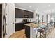 Modern kitchen with a granite island, black cabinets, and seating for four at 2904 Marlberry Ln, Clermont, FL 34714