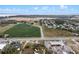 Aerial view displays the property and its surroundings, including nearby commercial spaces and distant water views at 29650 State Road 19, Tavares, FL 32778