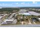 Aerial view displays the property and its surroundings, including commercial spaces, water views and surrounding neighborhood at 29650 State Road 19, Tavares, FL 32778