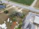 Aerial view showing a property beside commercial businesses, highlighting a large lot with trees and road access at 29650 State Road 19, Tavares, FL 32778