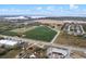 This aerial shows a large lot adjacent to farms, highways and water with other commercial buildings at 29650 State Road 19, Tavares, FL 32778