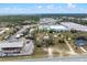 This aerial shows a large lot adjacent to highways and commercial buildings including storage units at 29650 State Road 19, Tavares, FL 32778