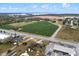 This aerial shows a large lot adjacent to farms, highways and water with other commercial buildings at 29650 State Road 19, Tavares, FL 32778