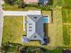 An aerial view shows the entire layout of this home's roof, yard and private pool at 30215 Island Club Dr, Deer Island, FL 32778