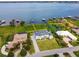 Aerial view showcases waterfront homes, private docks, and lush landscaping within the Deer Island Golf community at 30215 Island Club Dr, Deer Island, FL 32778