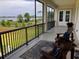 Covered balcony with waterfront views and lounge seating at 30215 Island Club Dr, Deer Island, FL 32778