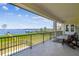 Spacious balcony with water views, lounge seating, and black railing at 30215 Island Club Dr, Deer Island, FL 32778