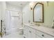 Bright bathroom featuring white marble tile, unique hardware and fixtures, and shower/tub combo at 30215 Island Club Dr, Deer Island, FL 32778