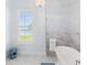 Bathroom featuring a soaking tub, crystal chandelier, shuttered windows, and decorative stool at 30215 Island Club Dr, Deer Island, FL 32778