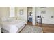 Comfortable bedroom featuring a beverage bar, ensuite bath, and neutral color palette at 30215 Island Club Dr, Deer Island, FL 32778