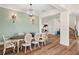 Formal dining room with elegant chandelier and view into the living room at 30215 Island Club Dr, Deer Island, FL 32778
