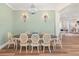 Elegant dining room with chandelier, wainscotting, and stylish decor at 30215 Island Club Dr, Deer Island, FL 32778