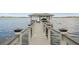 Private boat dock on the water with boat and shaded lounge area, great for lake access at 30215 Island Club Dr, Deer Island, FL 32778