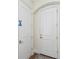 Entryway featuring a patterned rug and interior doors with bronze hardware at 30215 Island Club Dr, Deer Island, FL 32778