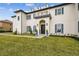 Elegant home entrance with a manicured lawn and walkway at 30215 Island Club Dr, Deer Island, FL 32778