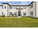 Elegant home featuring a manicured lawn, symmetrical landscaping, and classic architectural details at 30215 Island Club Dr, Deer Island, FL 32778