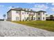 Stunning home with a beautiful lawn, long driveway, and lovely architectural details at 30215 Island Club Dr, Deer Island, FL 32778