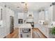 Bright eat-in kitchen featuring a large island, stainless steel appliances, and white cabinetry at 30215 Island Club Dr, Deer Island, FL 32778