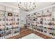 Upper level library featuring a wrought iron railing, hardwood floors, and floor to ceiling bookcases at 30215 Island Club Dr, Deer Island, FL 32778