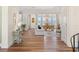 Open-concept living room and dining room with water views and lots of natural light at 30215 Island Club Dr, Deer Island, FL 32778