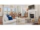 Comfortable living room with a fireplace, dining area, and view to the water at 30215 Island Club Dr, Deer Island, FL 32778