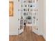 The office entrance features a double door that opens to a large bookshelf lined study at 30215 Island Club Dr, Deer Island, FL 32778