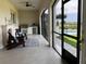 Relaxing patio with Adirondack chairs, outdoor kitchen, and a screened view of the pool at 30215 Island Club Dr, Deer Island, FL 32778