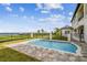 Beautiful backyard pool with brick surround and black metal safety fence overlooking the waterfront at 30215 Island Club Dr, Deer Island, FL 32778