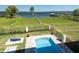Backyard pool and dock view, offering a relaxing waterfront experience with lake access at 30215 Island Club Dr, Deer Island, FL 32778